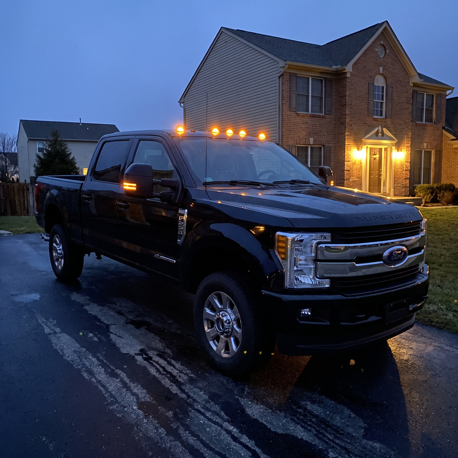 Five amber cab lights glowing on a Super Duty at dusk