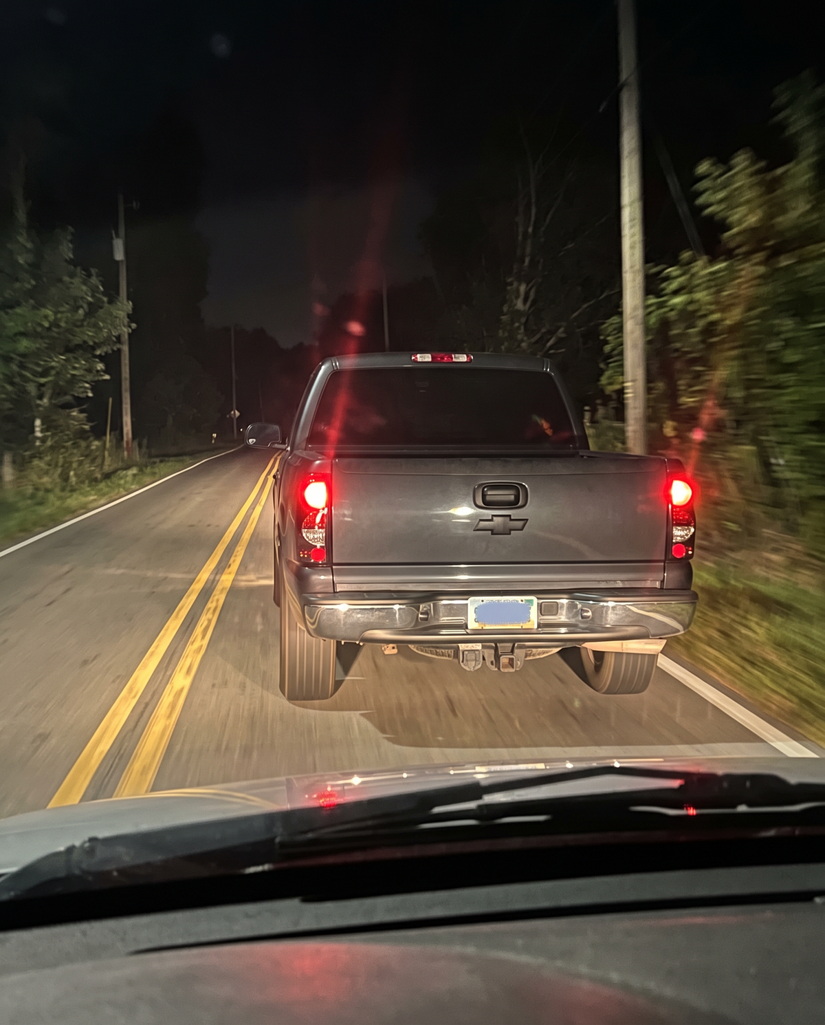 Silverado with smoked tail lights lit at night