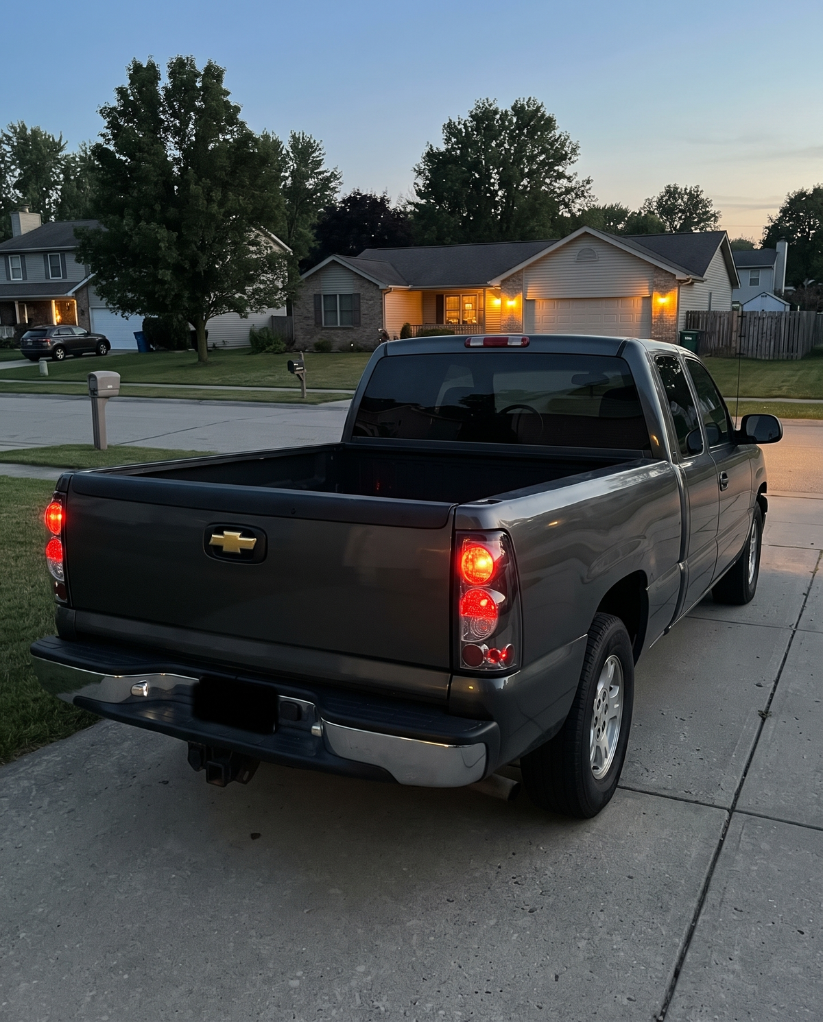 Smoked tail lights installed on a 1999-2006 Chevy Silverado at dusk