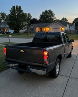 Smoked tail lights installed on a 1999-2006 Chevy Silverado at dusk