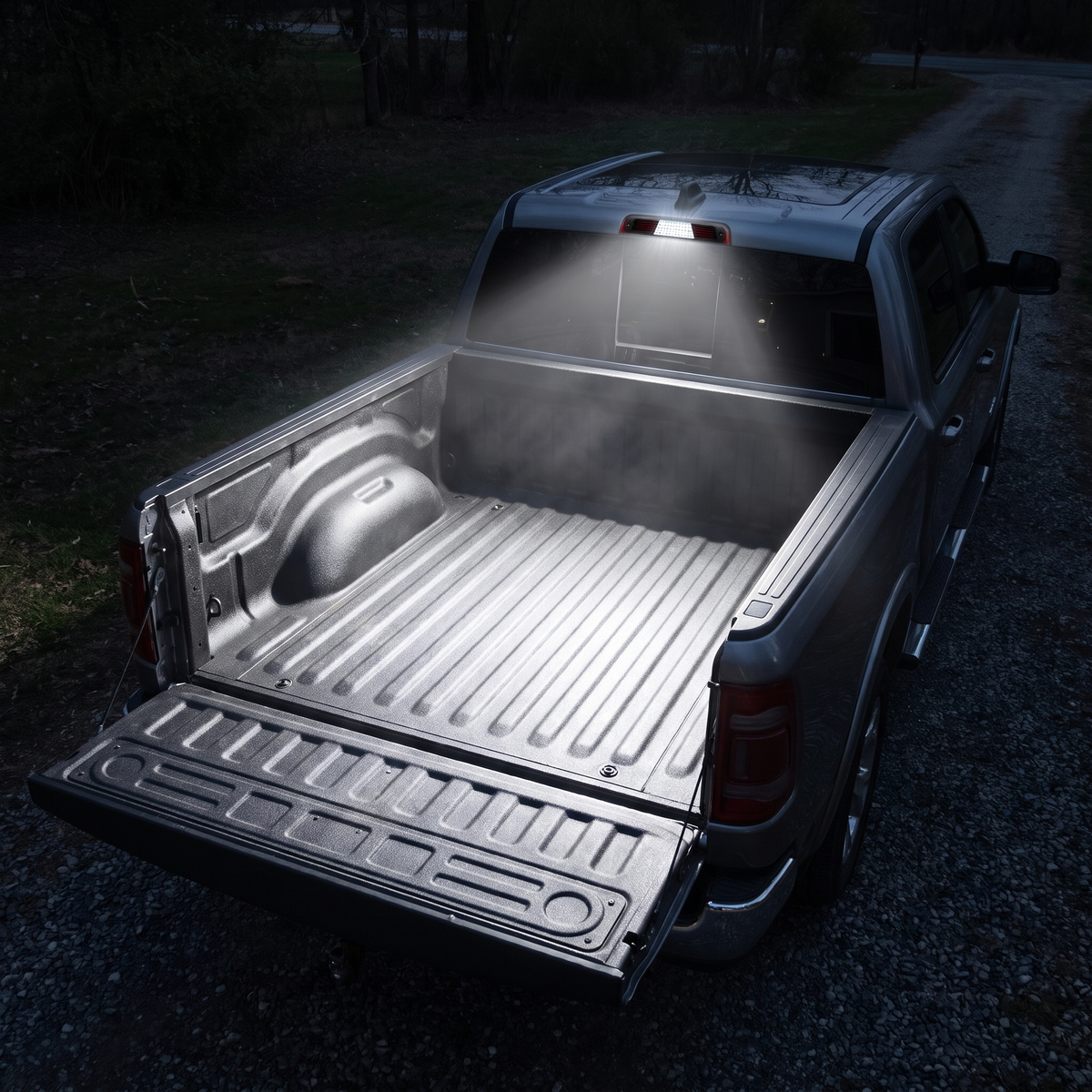 White LED cargo light illuminating 2019-2022 RAM 1500 truck bed at night
