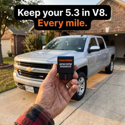 TruckEdge AFM/DFM Disabler in hand in front of a Chevy Silverado